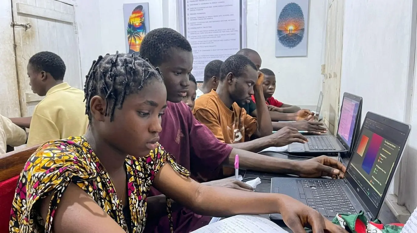 Students working on laptops during a Toshworld computer training session.